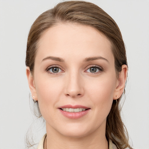 Joyful white young-adult female with medium  brown hair and blue eyes