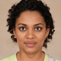 Joyful black young-adult female with medium  brown hair and brown eyes