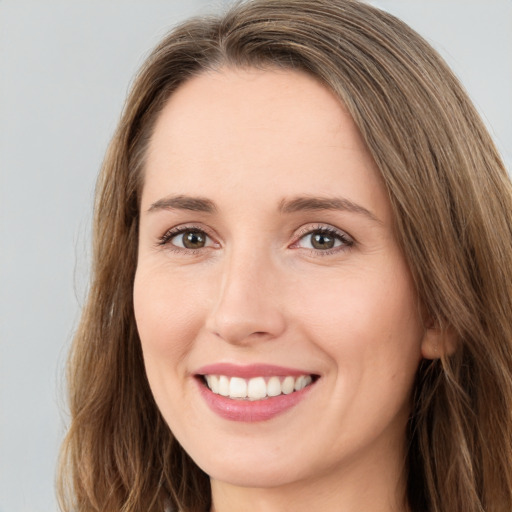 Joyful white young-adult female with long  brown hair and green eyes