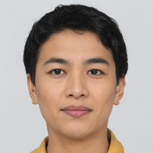 Joyful asian young-adult male with short  black hair and brown eyes