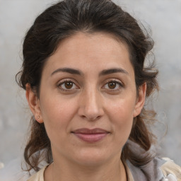 Joyful white adult female with medium  brown hair and brown eyes