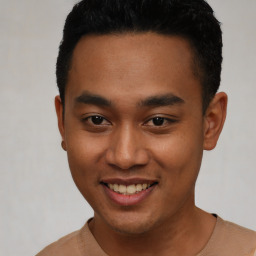 Joyful latino young-adult male with short  brown hair and brown eyes