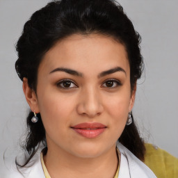 Joyful latino young-adult female with medium  brown hair and brown eyes