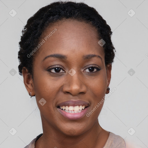 Joyful black young-adult female with short  black hair and brown eyes