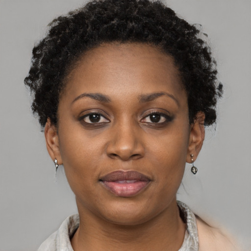 Joyful black young-adult female with short  brown hair and brown eyes