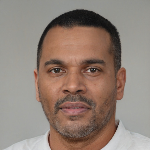 Neutral latino adult male with short  black hair and brown eyes
