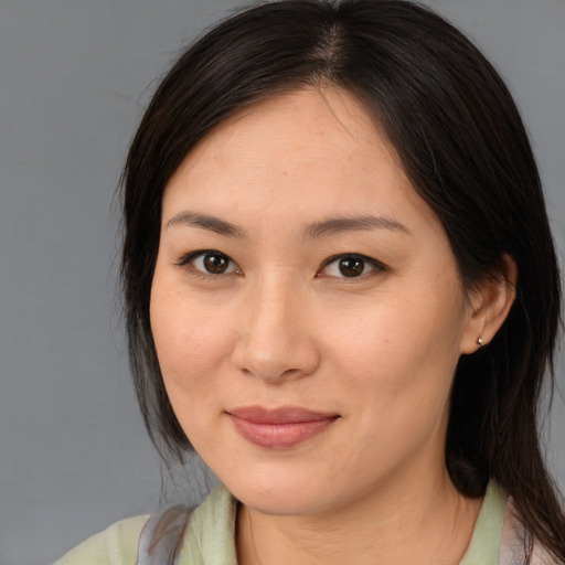 Joyful asian young-adult female with medium  brown hair and brown eyes