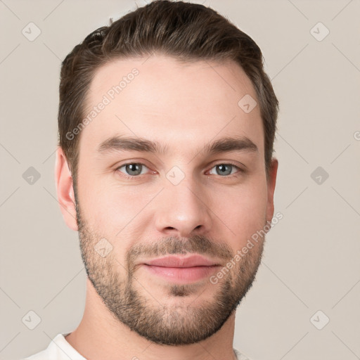 Joyful white young-adult male with short  brown hair and grey eyes