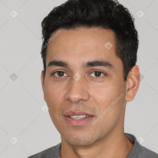 Joyful white young-adult male with short  black hair and brown eyes