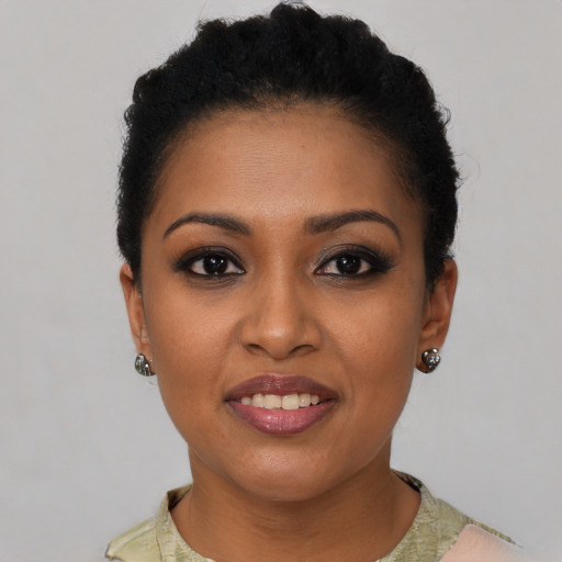 Joyful black young-adult female with short  brown hair and brown eyes