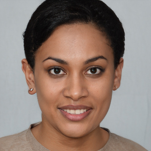 Joyful latino young-adult female with short  brown hair and brown eyes