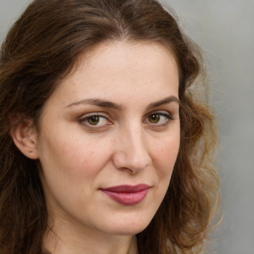 Joyful white young-adult female with long  brown hair and green eyes