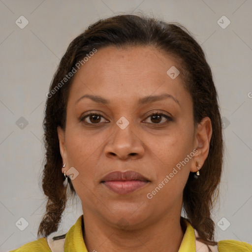 Joyful latino adult female with medium  brown hair and brown eyes