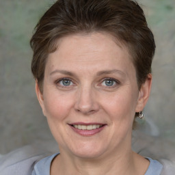 Joyful white adult female with short  brown hair and grey eyes