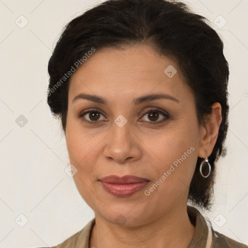 Joyful latino adult female with medium  brown hair and brown eyes