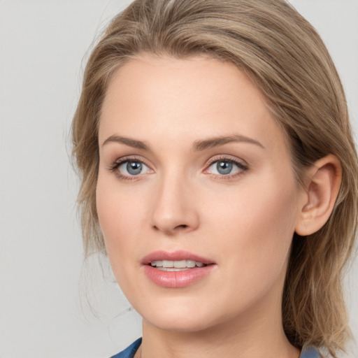 Joyful white young-adult female with medium  brown hair and blue eyes