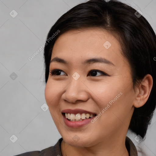 Joyful asian young-adult female with medium  brown hair and brown eyes