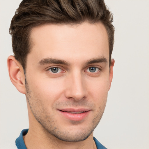 Joyful white young-adult male with short  brown hair and grey eyes