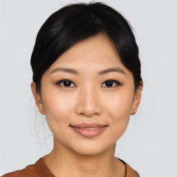 Joyful asian young-adult female with short  black hair and brown eyes