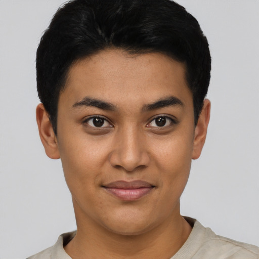 Joyful latino young-adult female with short  black hair and brown eyes