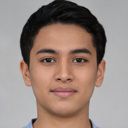 Joyful latino young-adult male with short  black hair and brown eyes