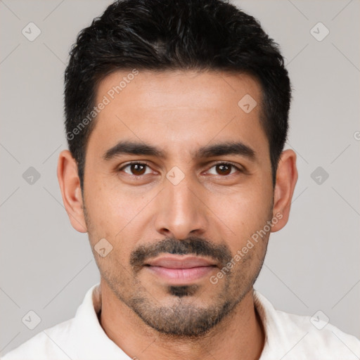 Joyful latino young-adult male with short  black hair and brown eyes