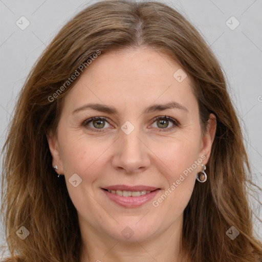 Joyful white adult female with long  brown hair and brown eyes