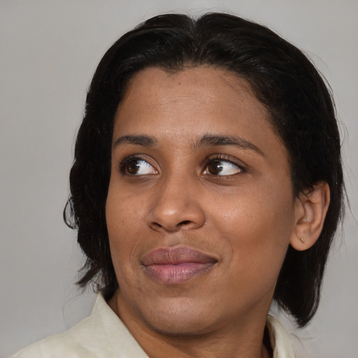 Joyful black young-adult female with medium  black hair and brown eyes