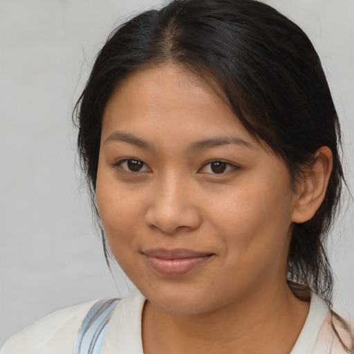 Joyful asian young-adult female with medium  brown hair and brown eyes