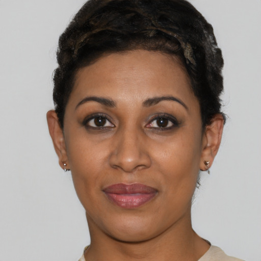 Joyful black young-adult female with short  brown hair and brown eyes
