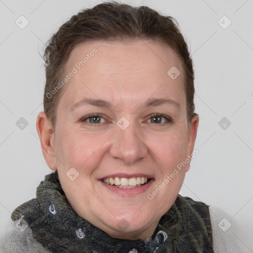 Joyful white adult female with short  brown hair and grey eyes