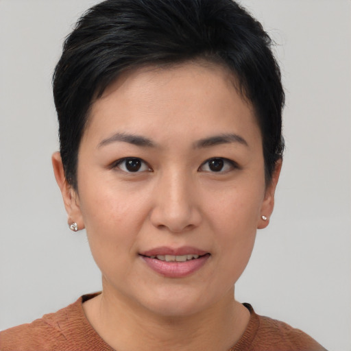 Joyful asian young-adult female with short  brown hair and brown eyes