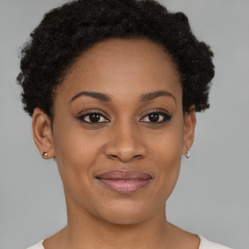 Joyful black young-adult female with short  brown hair and brown eyes