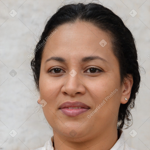 Joyful latino adult female with medium  brown hair and brown eyes