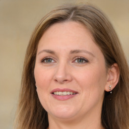 Joyful white adult female with medium  brown hair and grey eyes