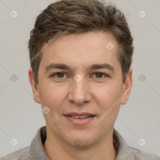 Joyful white adult male with short  brown hair and grey eyes