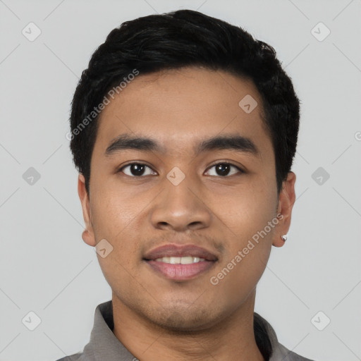 Joyful latino young-adult male with short  black hair and brown eyes