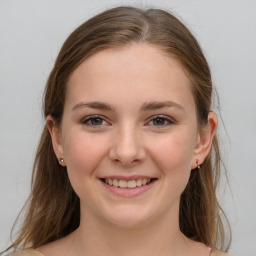 Joyful white young-adult female with medium  brown hair and grey eyes