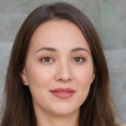 Joyful white adult female with long  brown hair and brown eyes