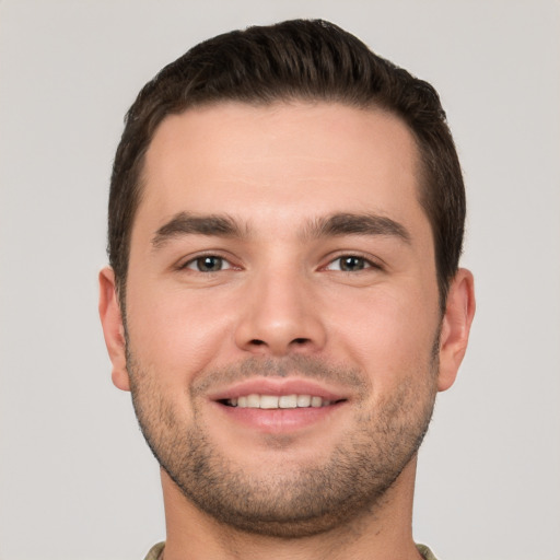 Joyful white young-adult male with short  brown hair and brown eyes