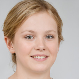 Joyful white young-adult female with medium  brown hair and blue eyes