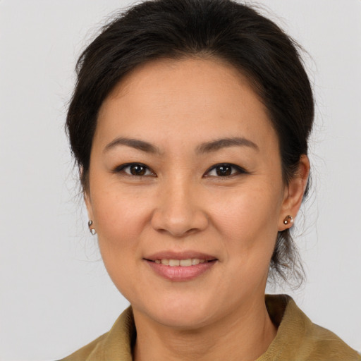 Joyful white adult female with medium  brown hair and brown eyes