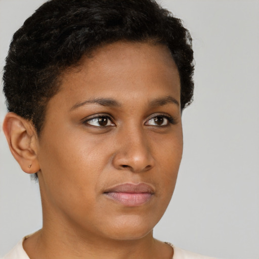 Joyful black young-adult female with short  brown hair and brown eyes