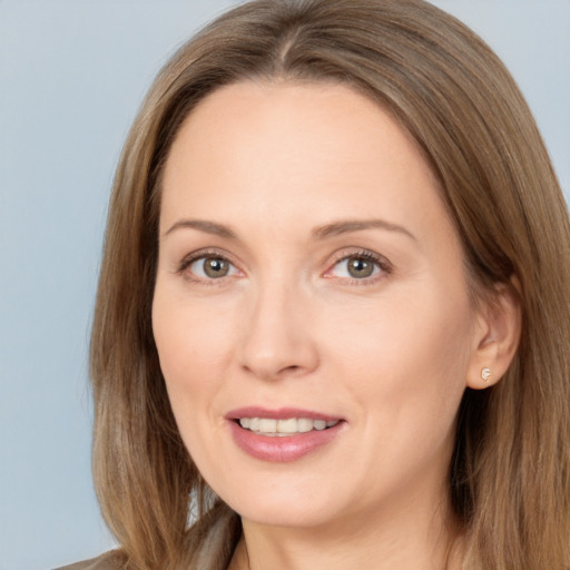 Joyful white adult female with long  brown hair and brown eyes