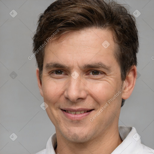 Joyful white adult male with short  brown hair and brown eyes