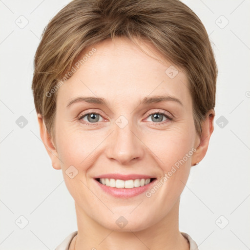 Joyful white young-adult female with short  brown hair and grey eyes