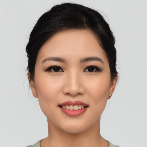 Joyful asian young-adult female with short  black hair and brown eyes