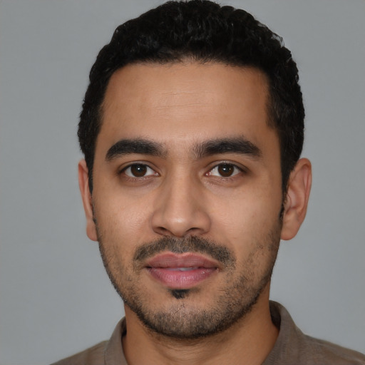 Neutral latino young-adult male with short  black hair and brown eyes