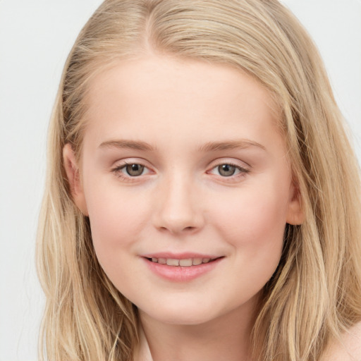 Joyful white child female with long  brown hair and blue eyes