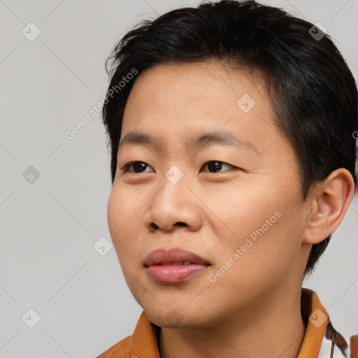 Joyful asian young-adult male with short  brown hair and brown eyes